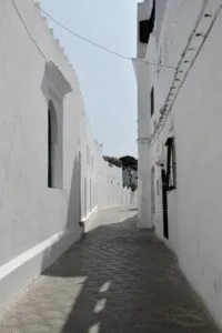 Narrow whitewashed alley in Asilah, Morocco, showcasing traditional architecture.Is Asilah Worth Visiting for Families