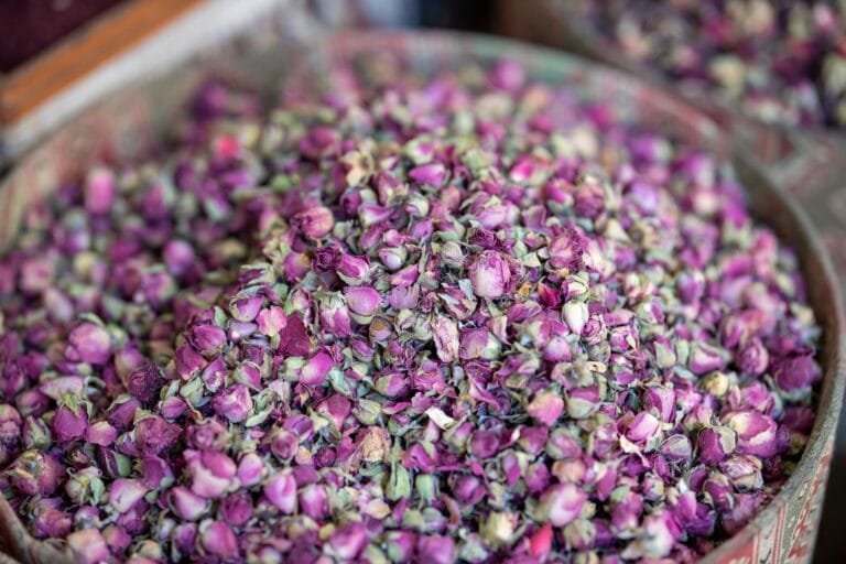 Aromatic pink rose buds piled in a bowl, perfect for tea, potpourri, or decorflower of morocco.