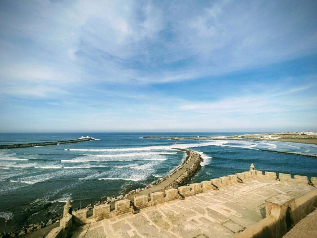 a large body of water with waves coming in. Kasbah of the Udayas.Is Rabat Worth Visiting With Kids