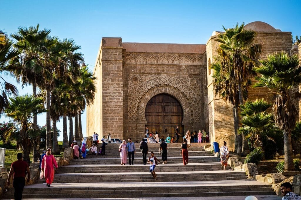 Tourists at Bab Oudaia Gate, Rabat, enjoying a sunny day by the iconic landmark.Is Rabat Safe for Families