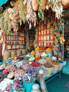 Baskets of colorful spices and dried flowers in a traditional Moroccan market stall.Tipping in Morocco