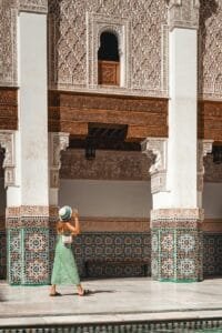 a woman in a green dress and a hat.Tipping in Morocco