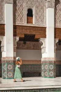 a woman in a green dress and a hat.Tipping in Morocco