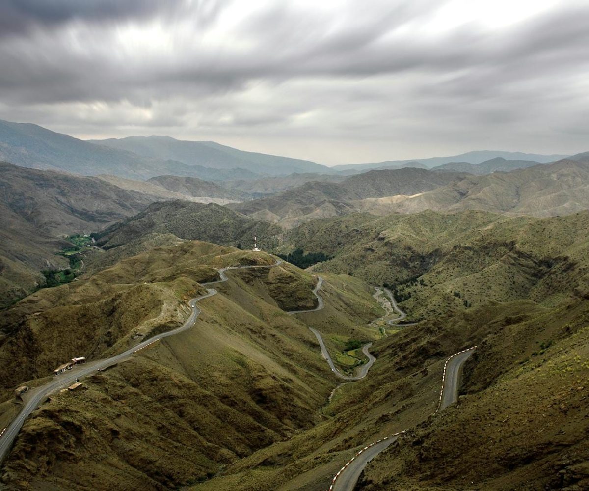 A scenic view of winding roads in the High Atlas Mountains near Ouarzazate, Morocco.10 day Morocco tour from Casablanca