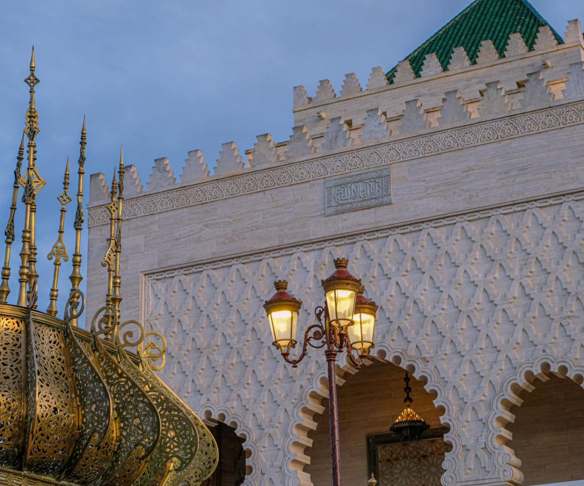 Beautiful Moroccan architecture with ornate lamps and intricate designs at sunset.10 day Morocco tour from Casablanca
