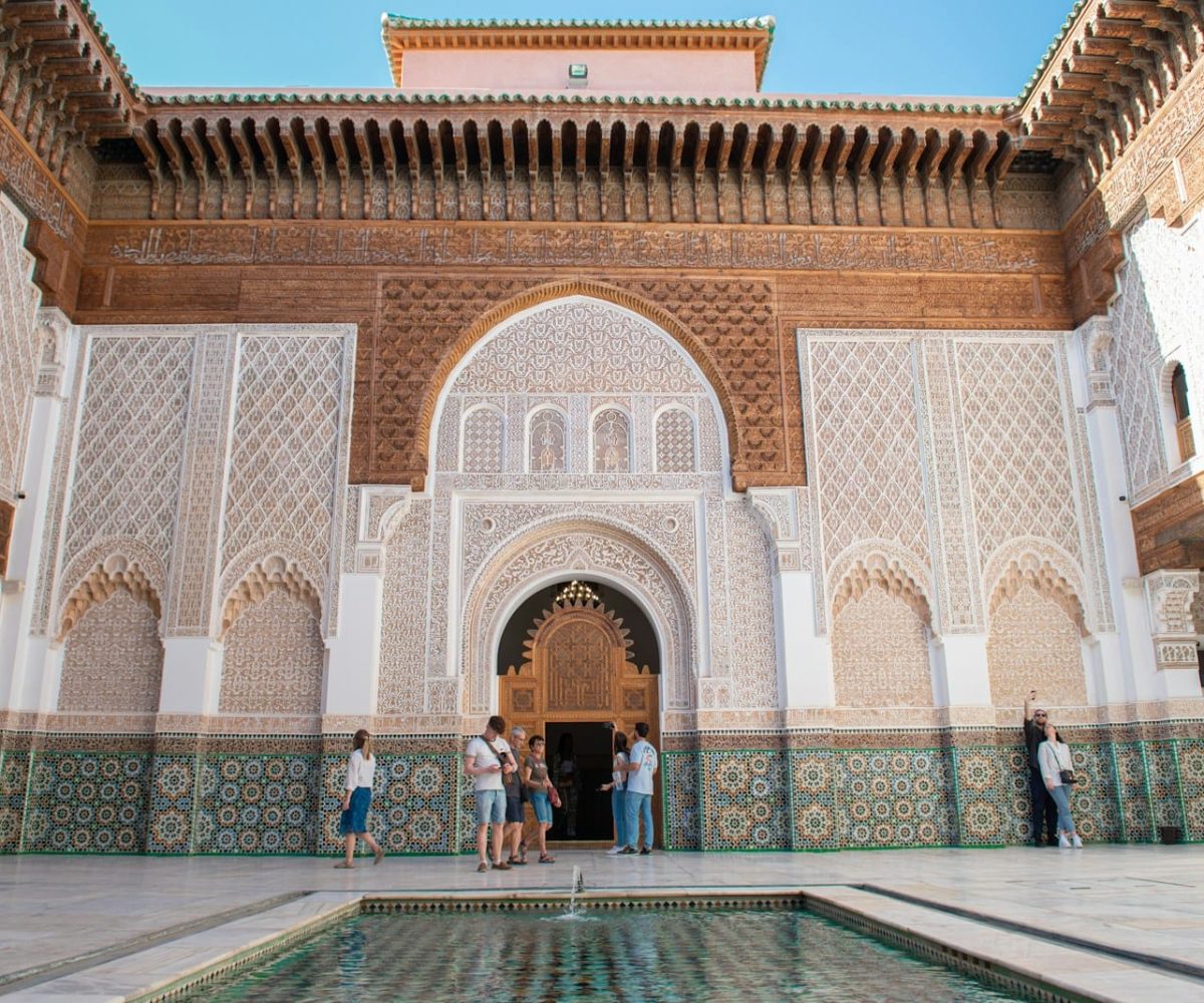 A group of people standing around a pool in a building,10 day Morocco tour from Casablanca