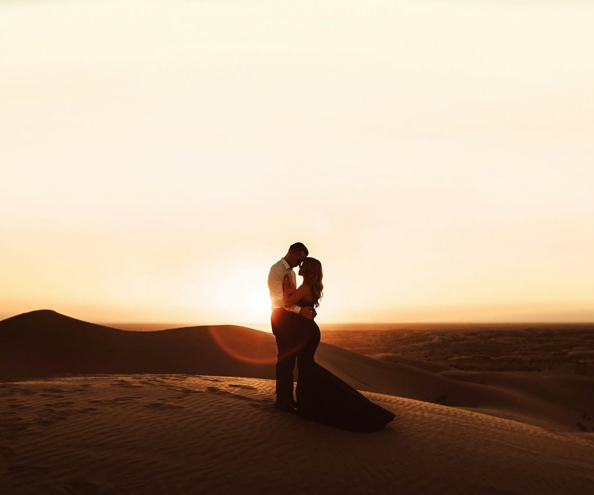 woman in black bikini standing on brown sand during sunset,marrakech to merzouga