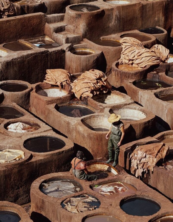 a man standing in front of a large number of pots