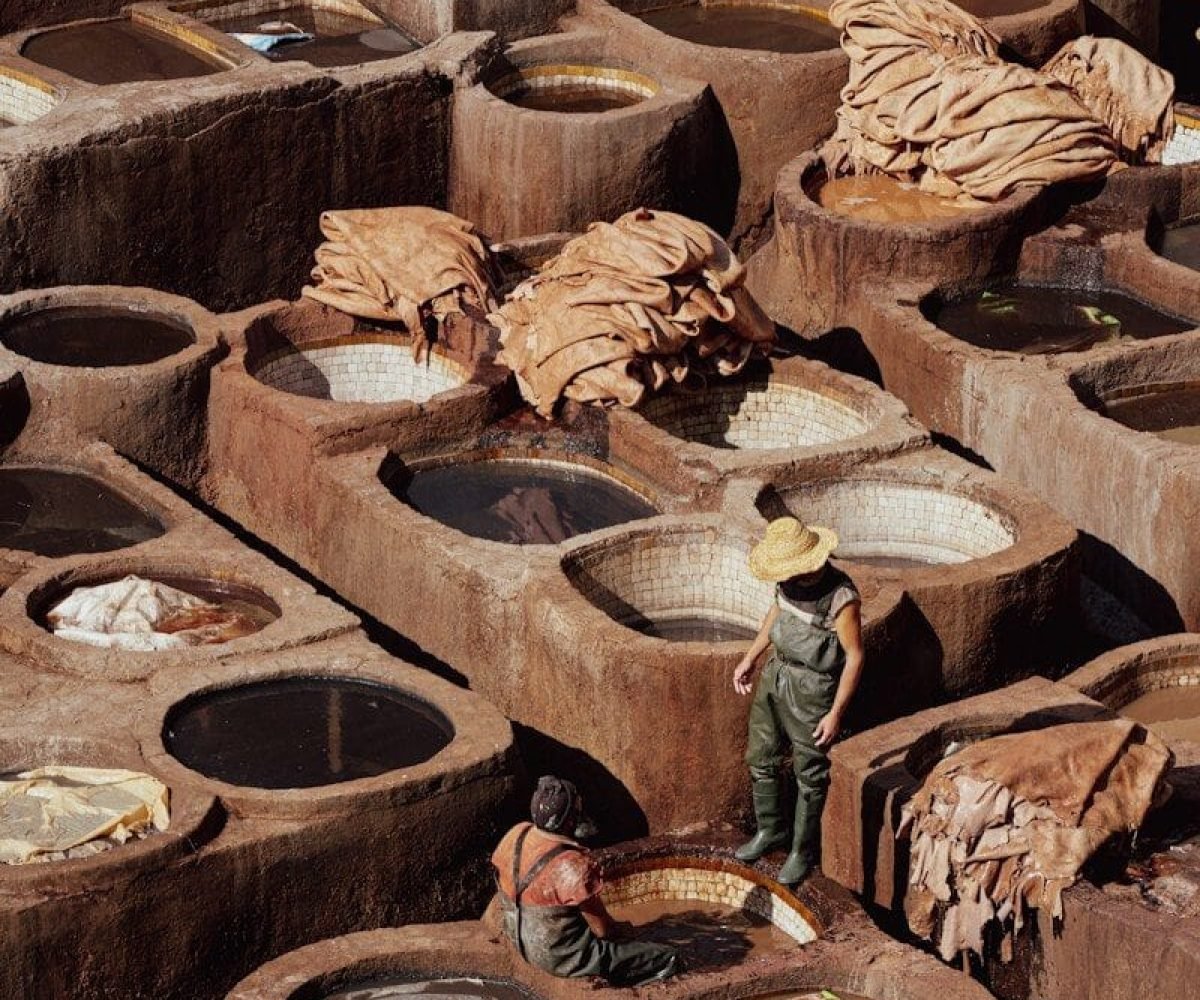 a man standing in front of a large number of pots