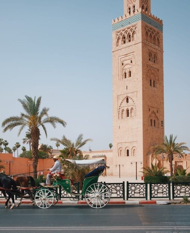 A horse-drawn carriage passing the Koutoubia Mosque in Marrakech, Morocco