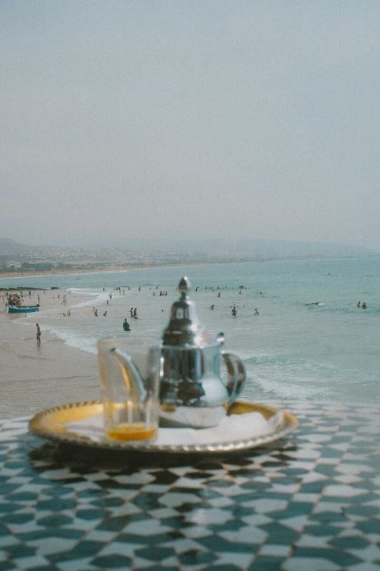 Moroccan teapot and glass overlooking taghazout beach