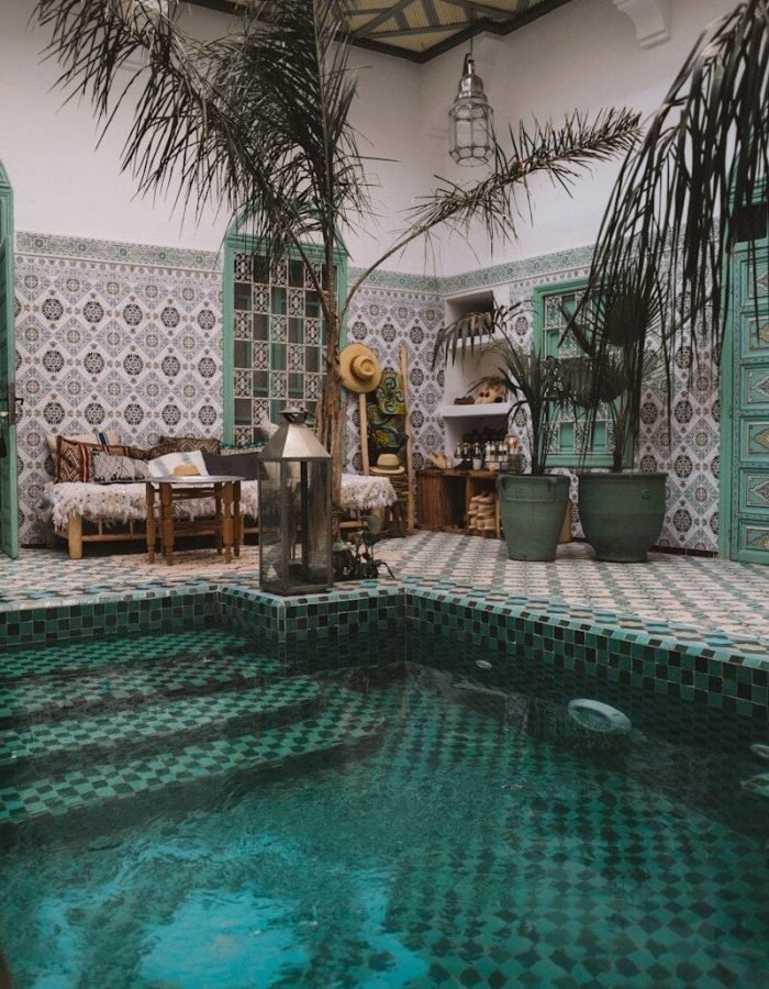 ground pool near wooden lounges