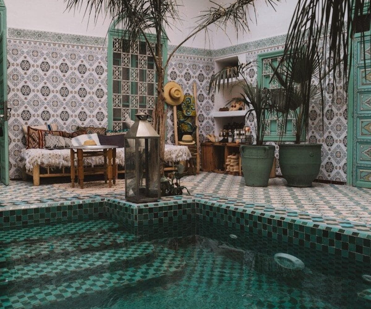 ground pool near wooden lounges