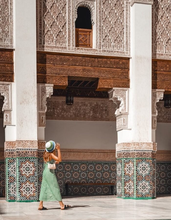 a woman in a green dress and a hat