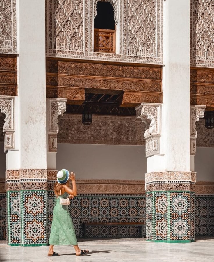 a woman in a green dress and a hat