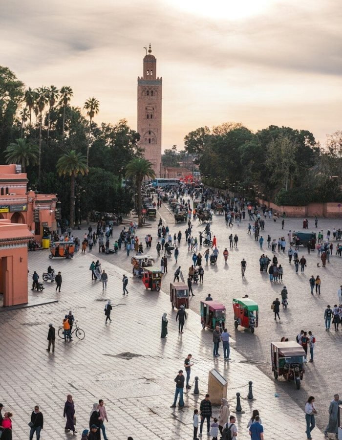 a large group of people walking around a plaza