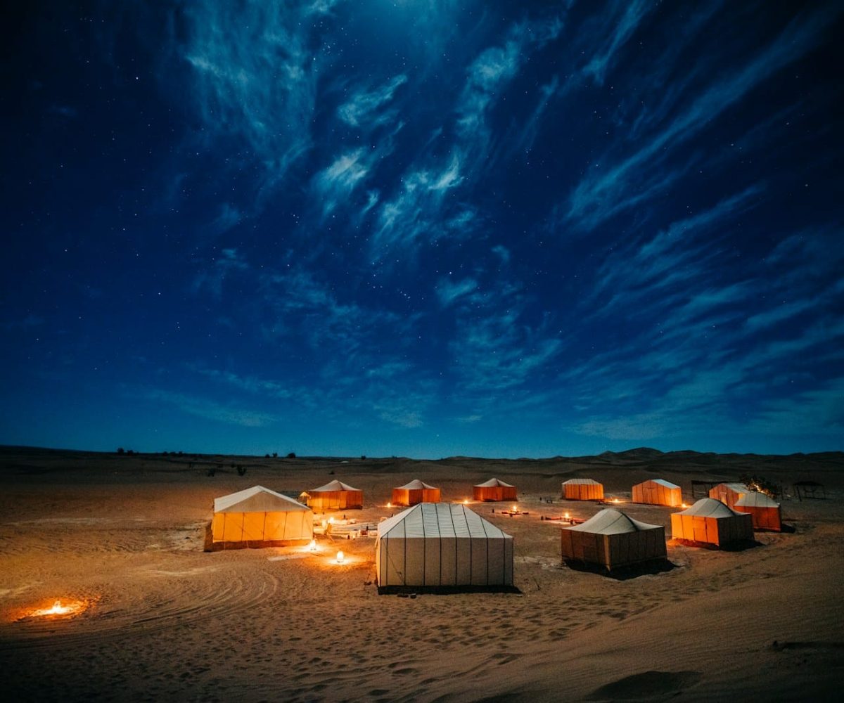white and brown tent on brown field under blue sky during night time,5 days marrakech to merzouga tour