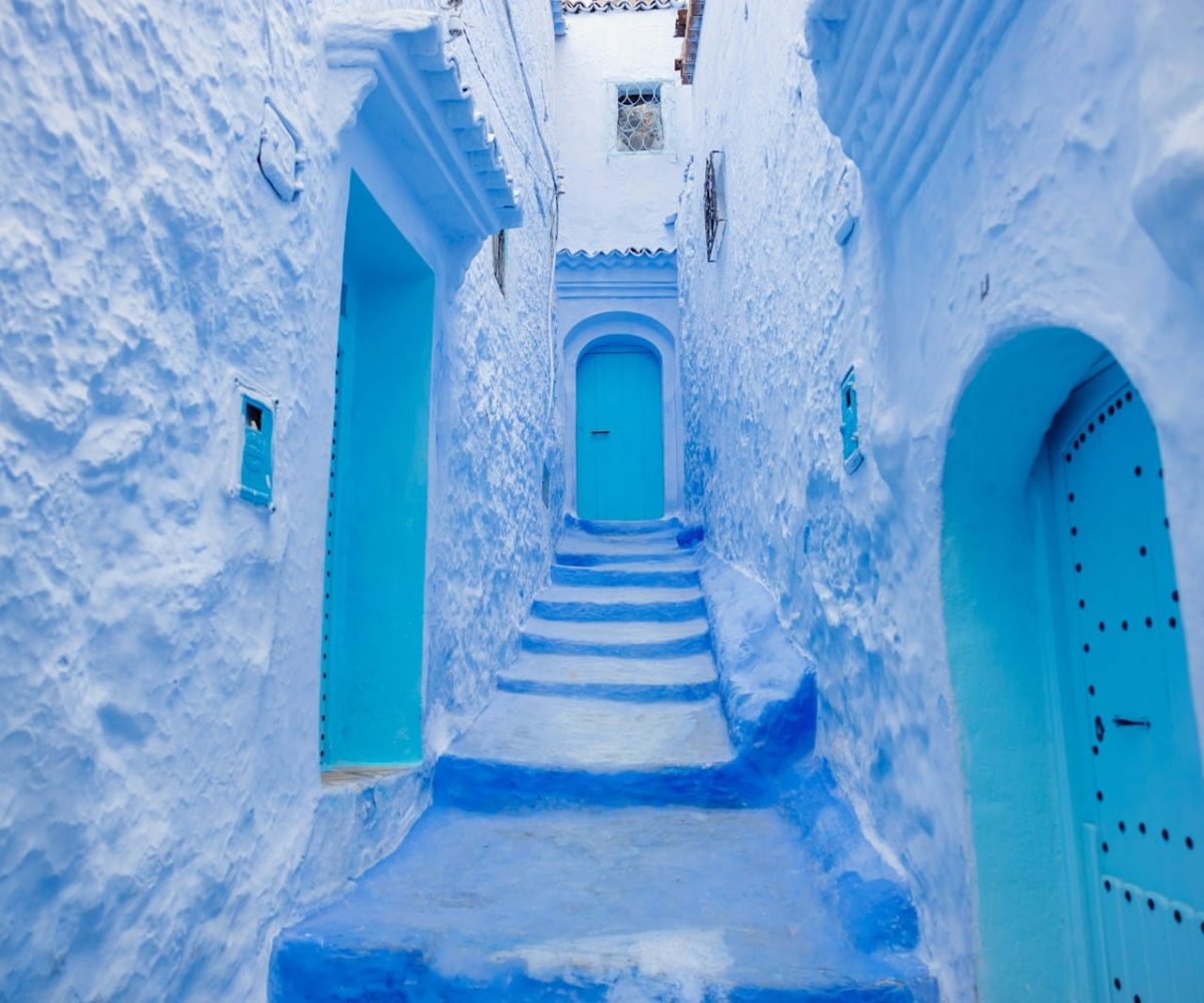a narrow alley way with blue painted steps,2 Days Casablanca to Chefchaouen,2 Days Casablanca to Chefchaouen