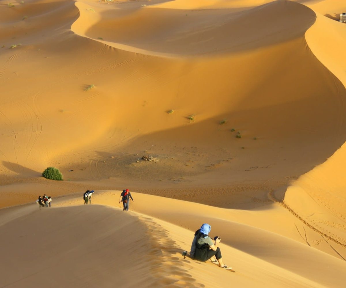 group of people standing on desert,5 days marrakech to merzouga tour