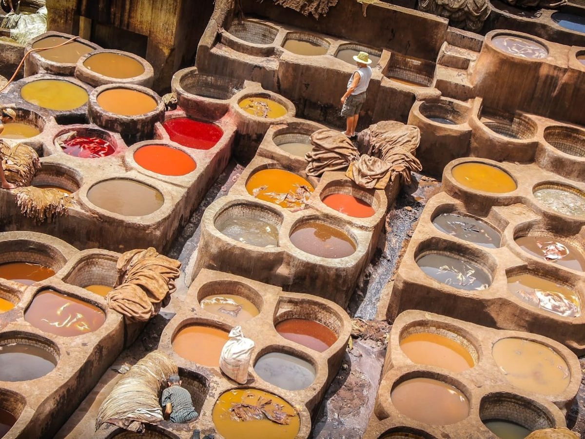 a table filled with lots of different colors of paint,7 days tour from casablanca